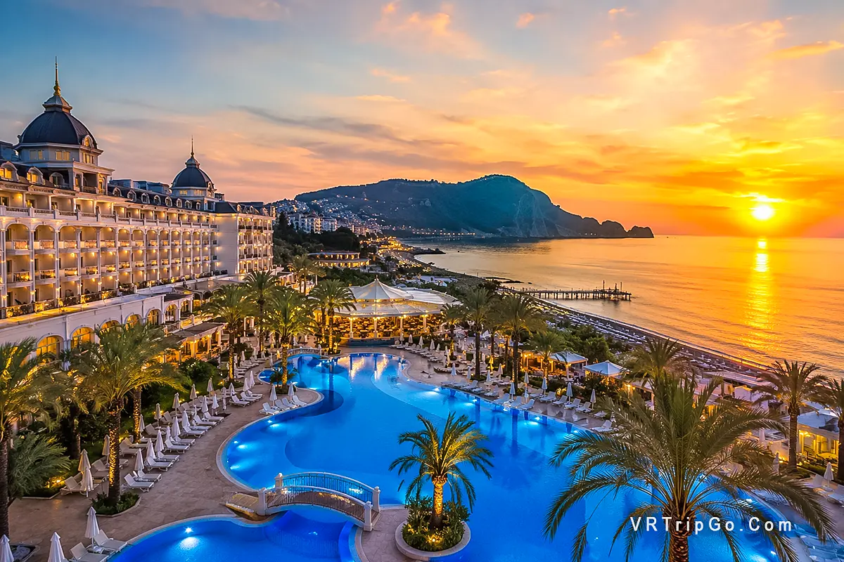 Best hotels in Alanya with luxury beachfront resort, swimming pool, palm trees and sunset sea view, top accommodation in Alanya Turkey