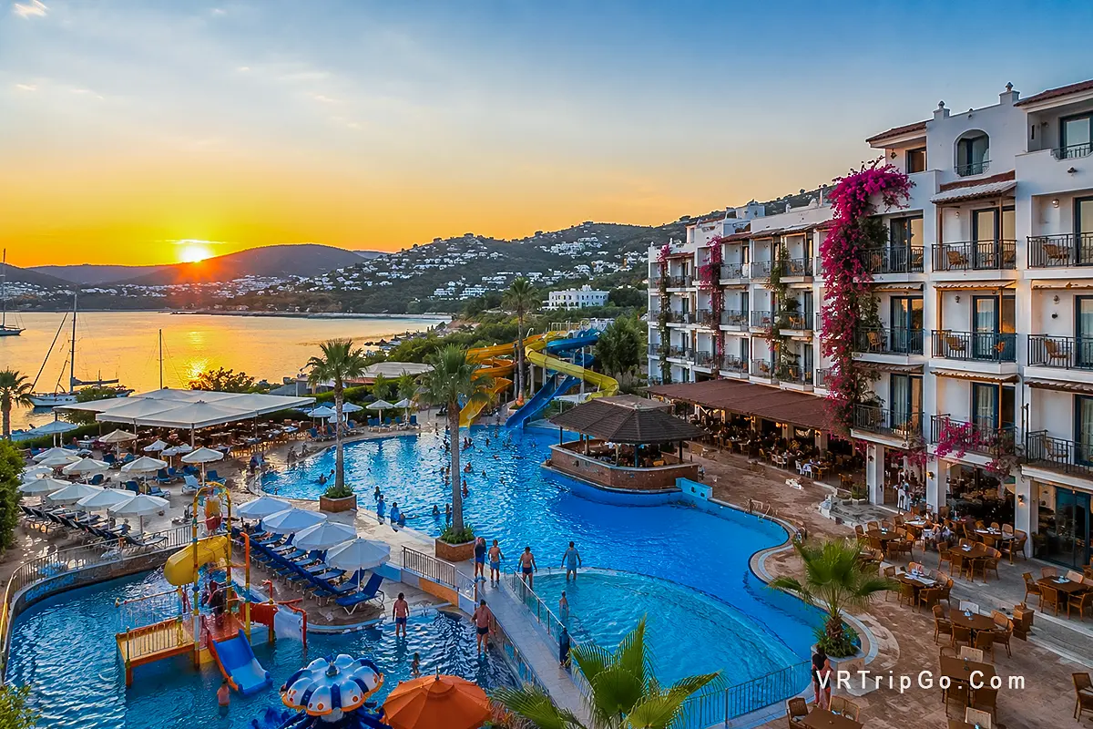 Best Family Hotels in Bodrum beachfront resort with kids pool, water slides and family friendly hotel at sunset in Turkey