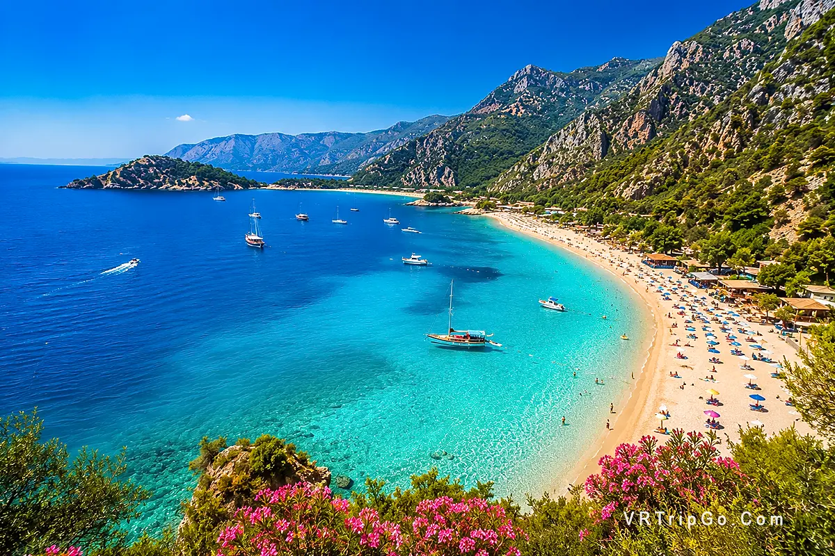 Best beaches in Oludeniz with crystal-clear turquoise sea, scenic Mediterranean coastline, luxury beach atmosphere and mountain views near the Blue Lagoon.