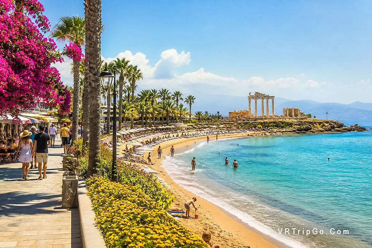 Side weather in spring beach promenade people walking sunny day Antalya Turkey