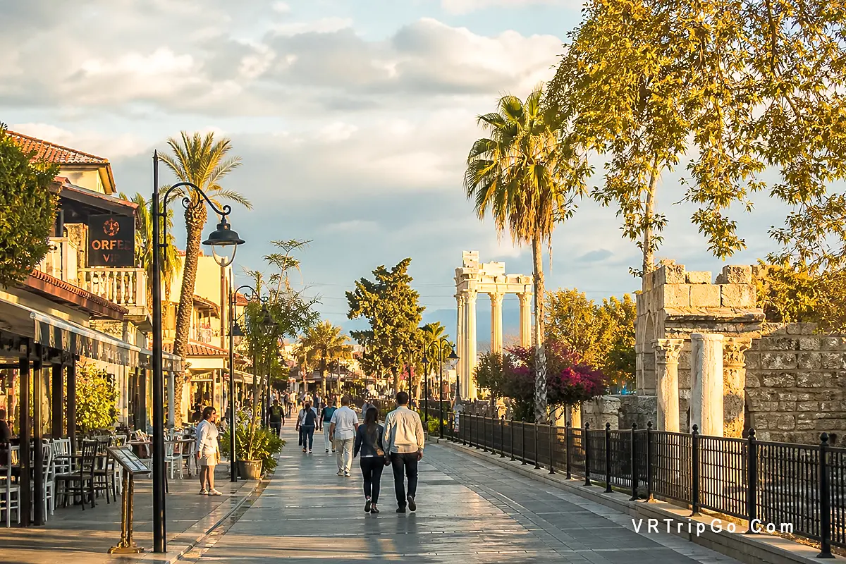 Side old town promenade shops cafes walking people budget travel prices Antalya Turkey