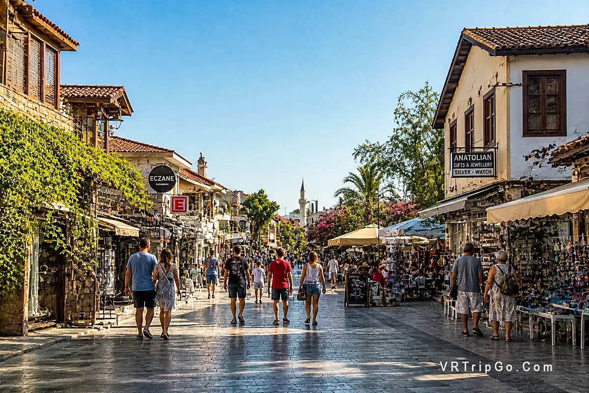 Best month to visit Side old town street shops cafes tourists walking sunny day Antalya Turkey