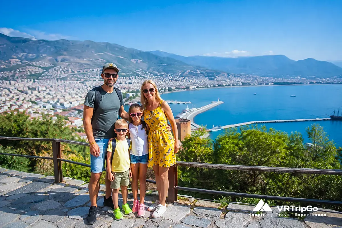 Family excursions in Alanya with parents and kids enjoying scenic viewpoint over coastline and city, fun and safe activities for family holidays in Alanya Turkey