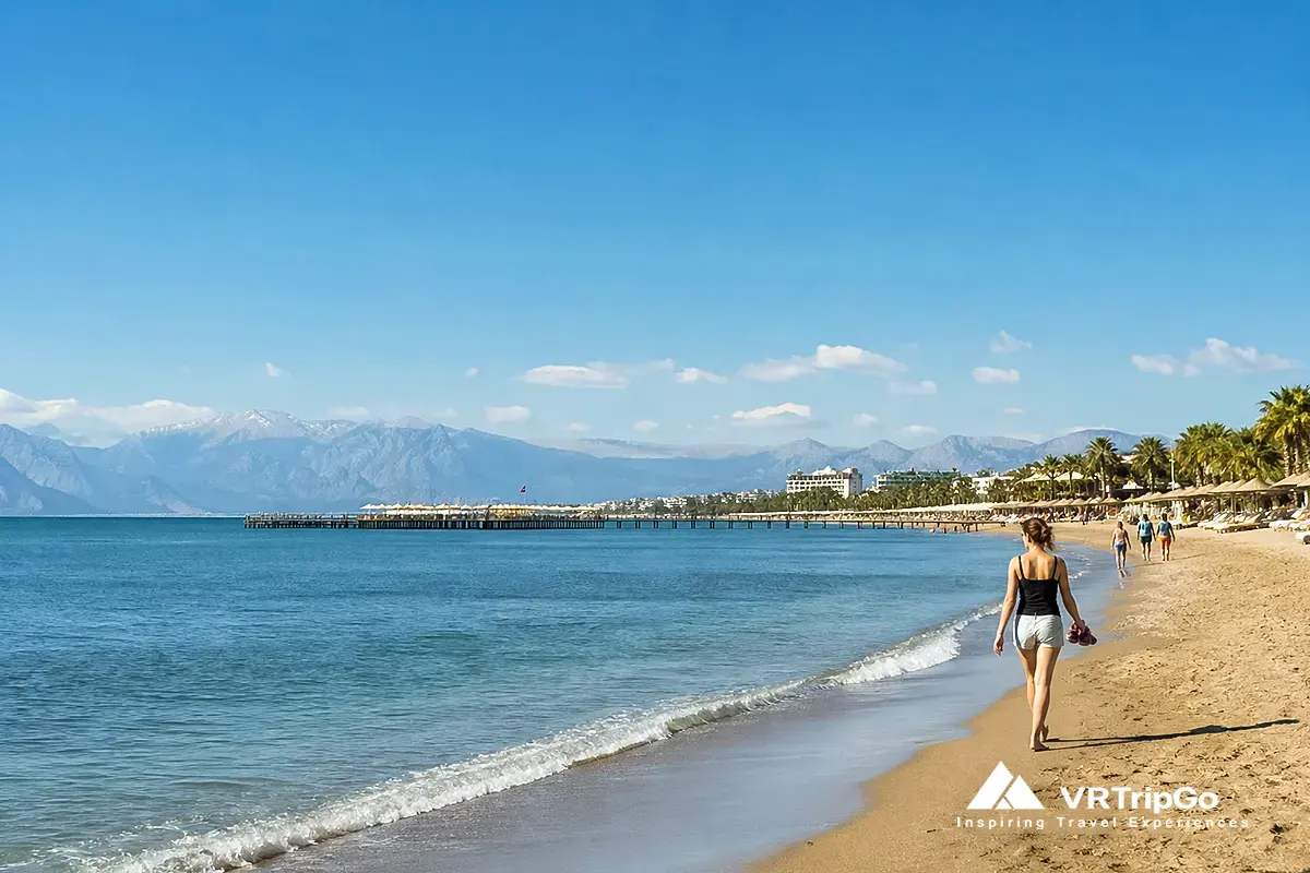 Belek beach in spring weather, sunny day with light breeze, calm sea, people walking along sandy shore, Antalya Turkey