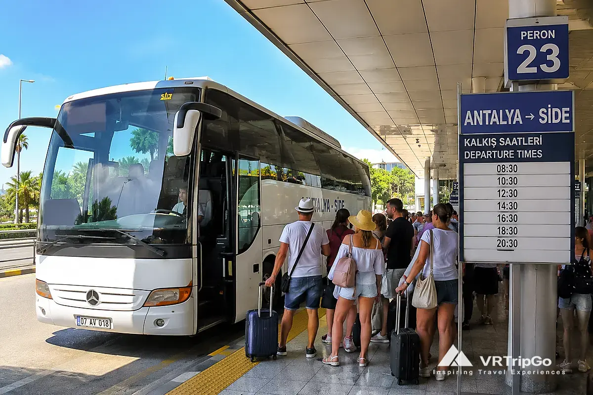 Budget bus from Antalya Airport to Side with tourists waiting at the shuttle station