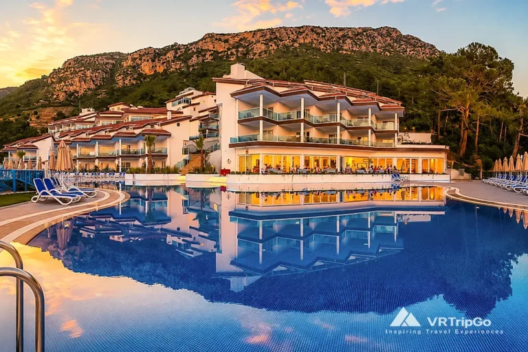 Luxury hotels in Oludeniz mountain resort with infinity pool and sunset reflection view