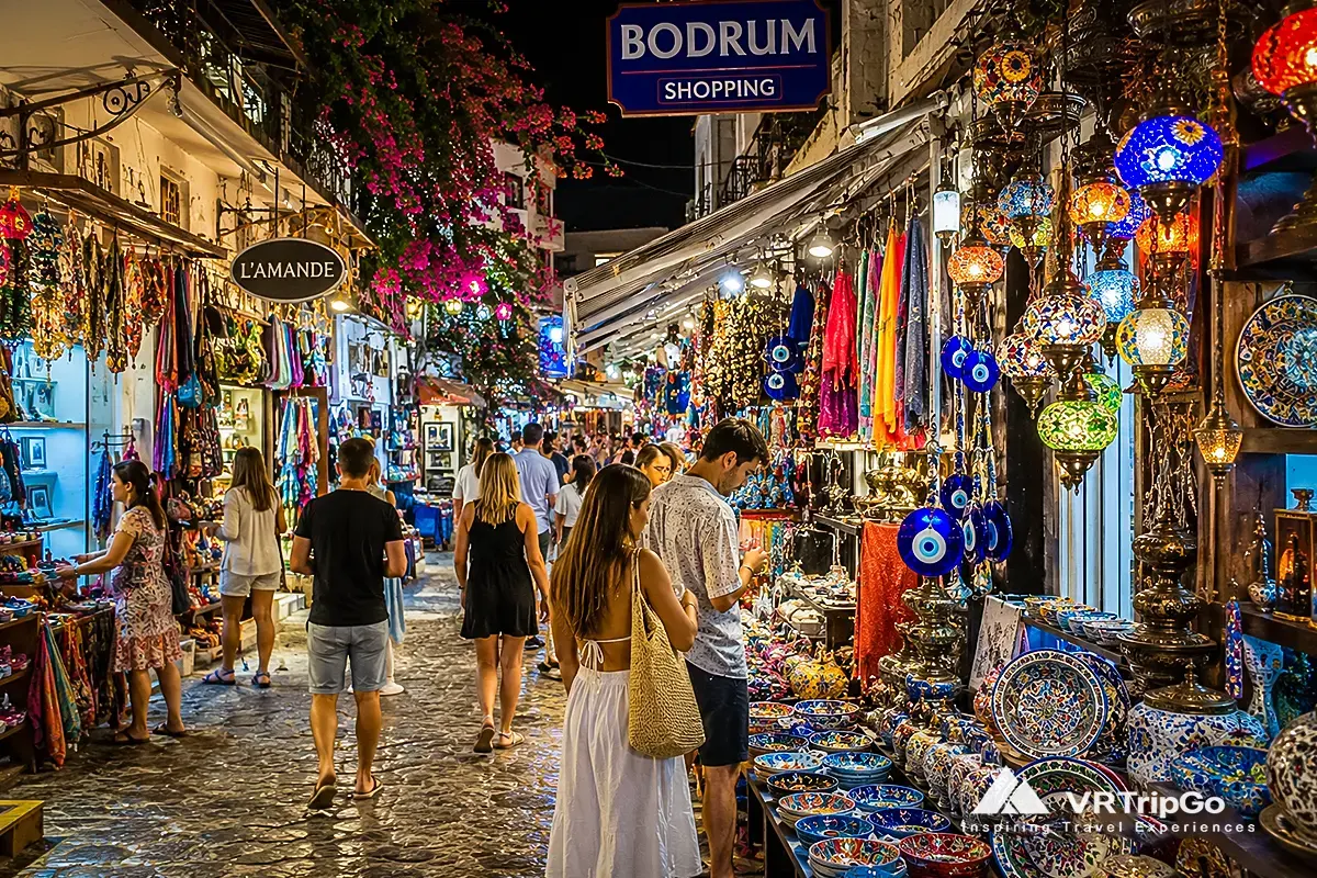 Shopping in Bodrum colorful Turkish bazaar with local souvenirs, lanterns and busy market street at night in Turkey