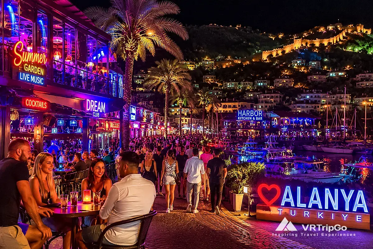 Nightlife in Alanya with vibrant harbor bars, neon lights and crowded promenade, people enjoying nightlife and live music by the sea in Alanya Turkey