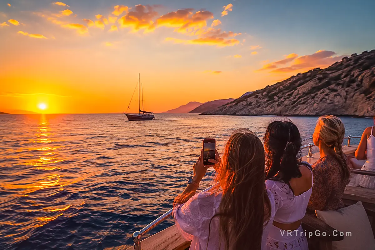 Sunset Boat Trip with Guests Enjoying a Golden Mediterranean Sunset at Sea