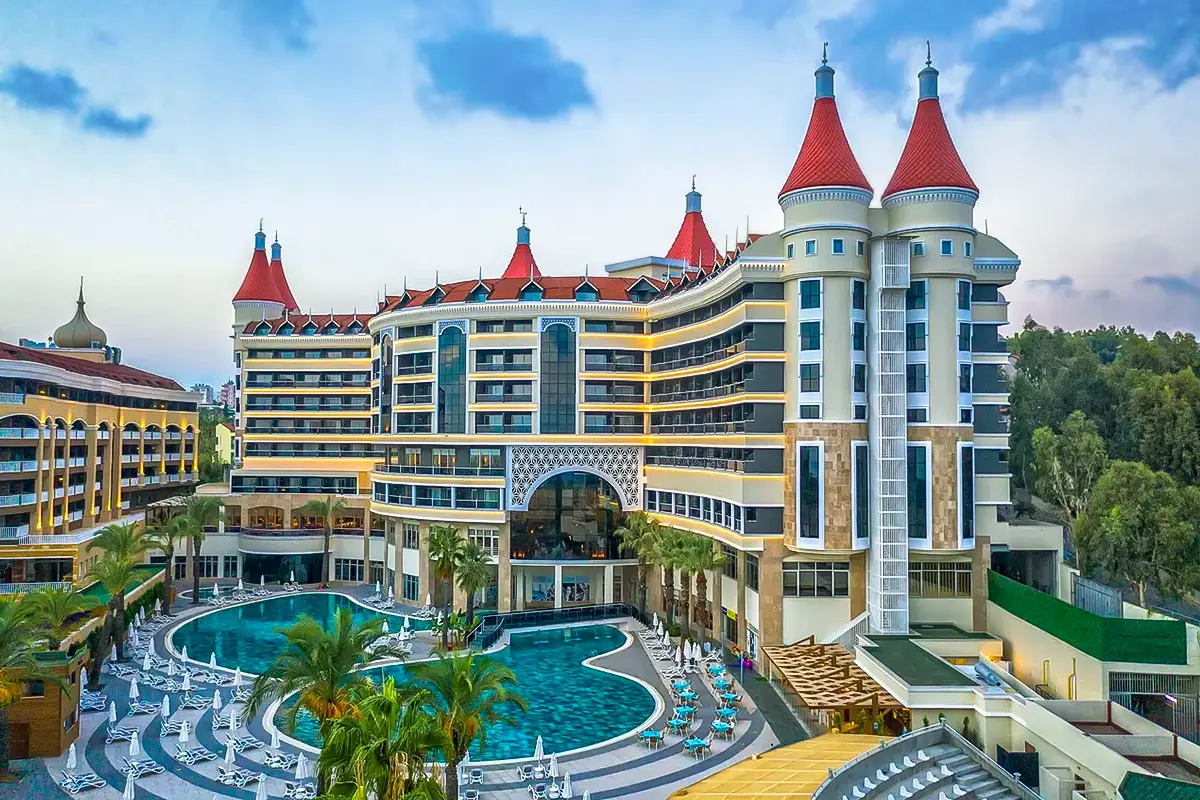 Kirman Leodikya Resort, one of the Best Family Hotels in Alanya, with turquoise pools and red-roofed towers in Okurcalar, Turkey.