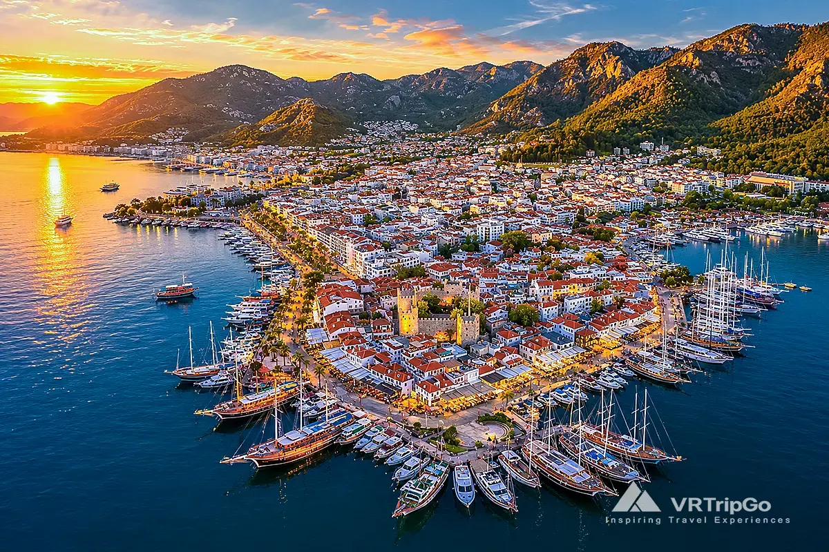 Best Excursions in Marmaris featuring a panoramic aerial view of Marmaris Marina, the historic old town, luxury yachts, and the scenic coastline at sunset.