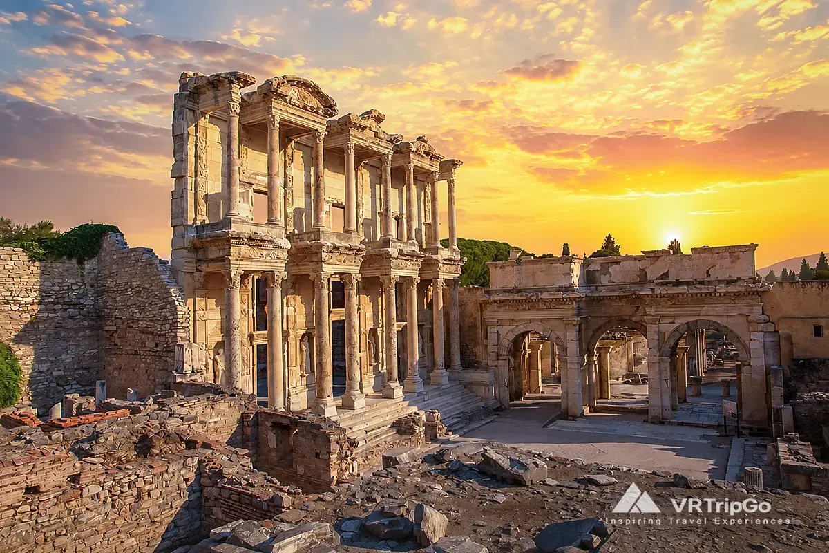 Ephesus Tour from Marmaris featuring the iconic Library of Celsus illuminated by a beautiful sunset sky in the ancient city of Ephesus.