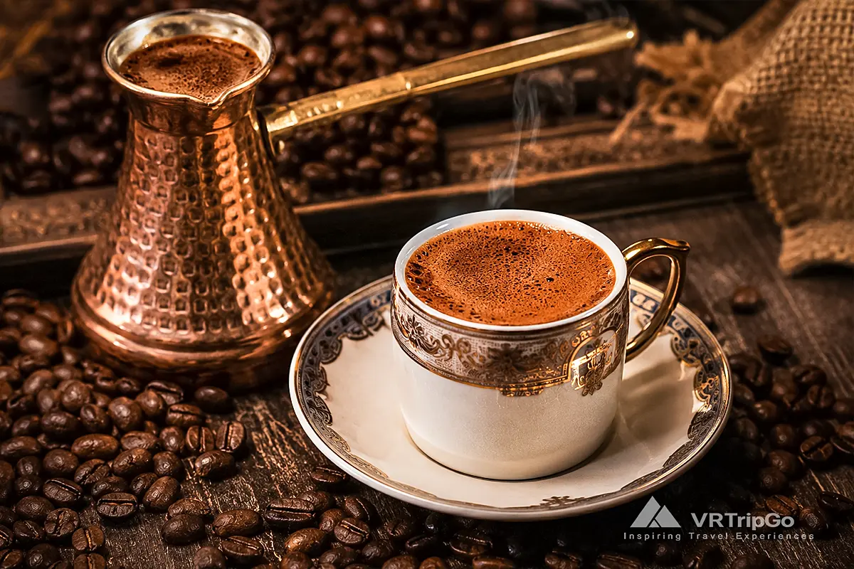 Turkish Coffee from Alanya served in a traditional ornate cup with rich coffee foam, roasted coffee beans, and an authentic copper cezve