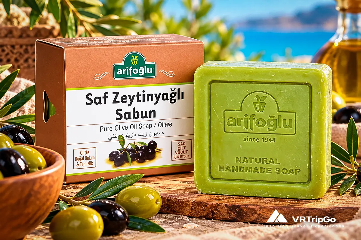 Turkish olive oil soap by Arifoglu in original packaging, made with olive oil, displayed with fresh olives and olive branches.