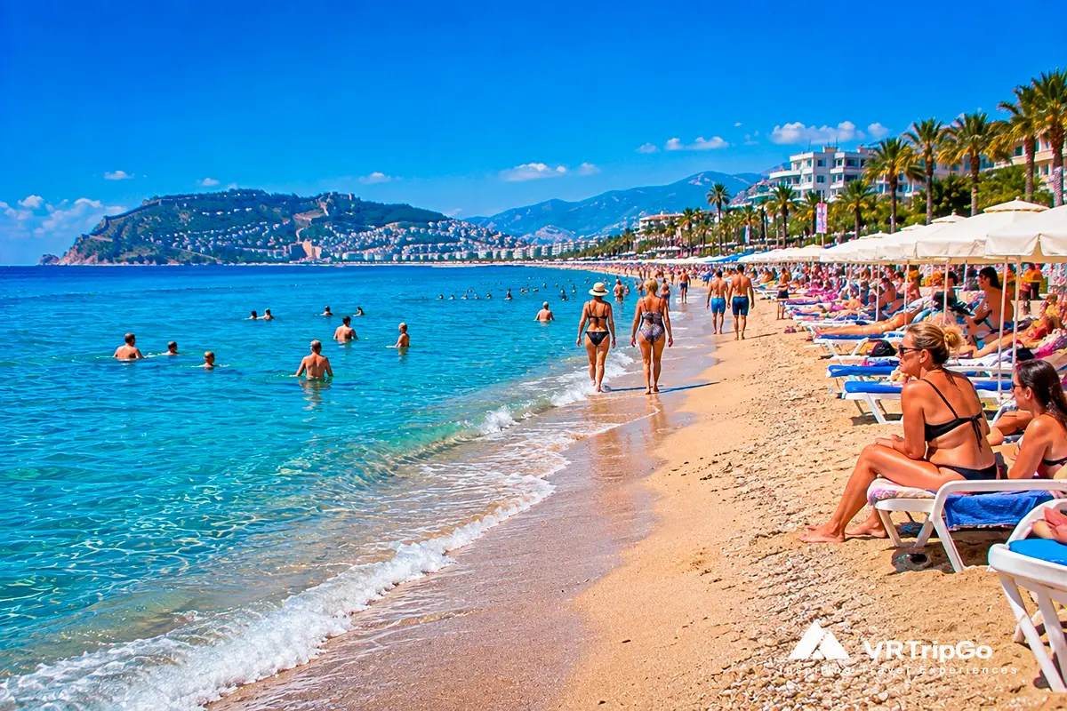 Keykubat Beach in Alanya, Turkey, with turquoise Mediterranean waters, a sandy shoreline, sun loungers, palm trees, beachgoers, and views of the Alanya Castle peninsula.